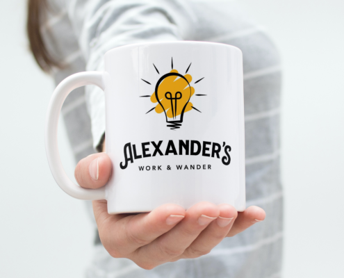 Alexander's Work and Wander Coffee Mug held out in lady's hand